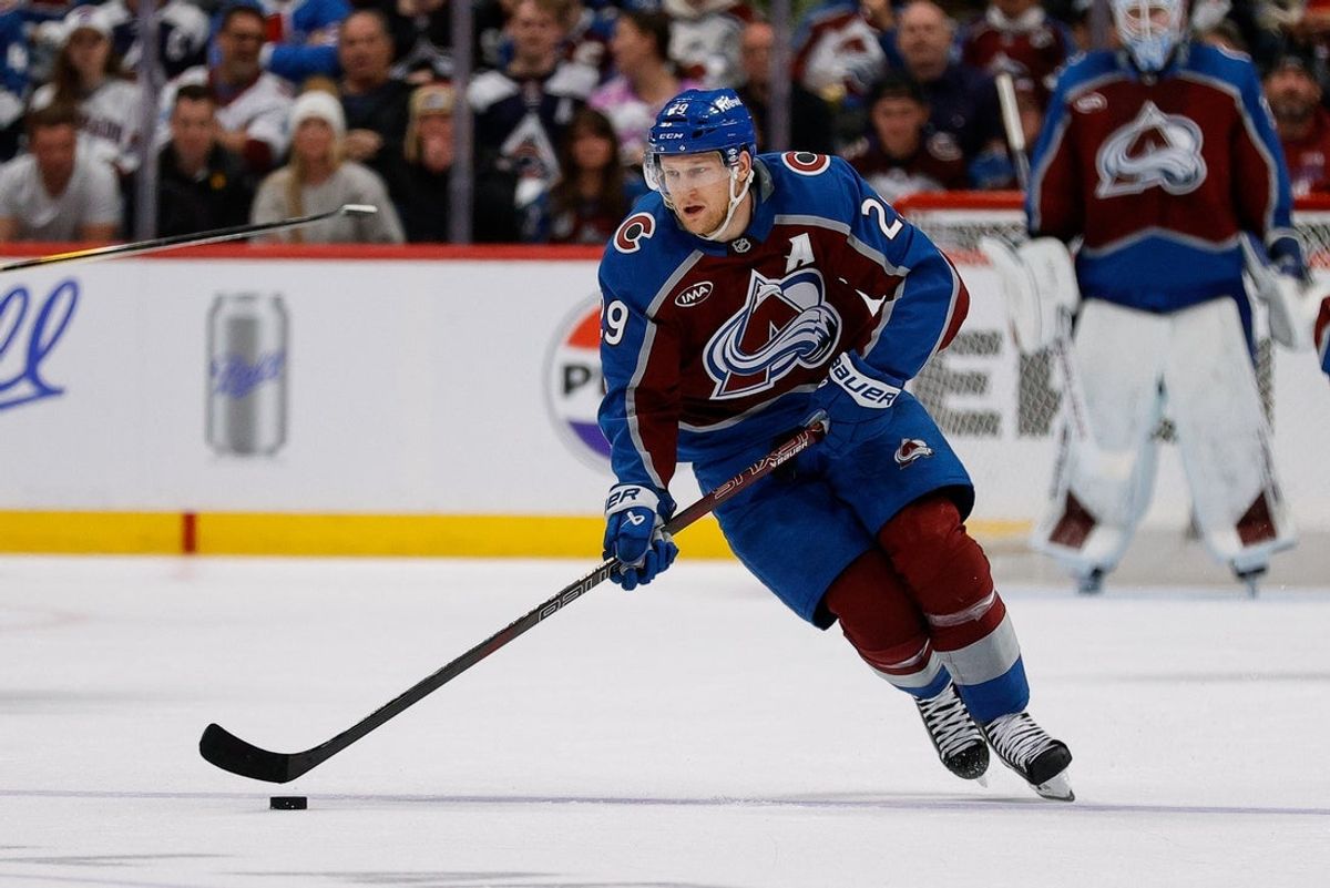 Apr 23, 2025; Denver, Colorado, USA; Colorado Avalanche center Nathan MacKinnon (29) controls the puck in the second period against the Dallas Stars in game three of the first round of the 2025 Stanley Cup Playoffs at Ball Arena. Mandatory Credit: Isaiah J. Downing-Imagn Images