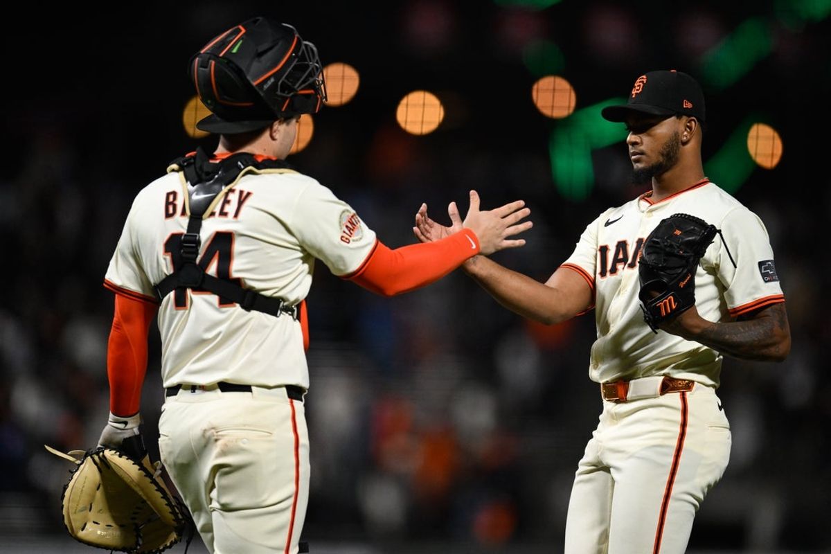 Apr 23, 2025; San Francisco, California, USA; San Francisco Giants pitcher Camilo Doval (75) and catcher Patrick Bailey (14) celebrate their win over the Milwaukee Brewers in the seventh inning at Oracle Park. Mandatory Credit: Eakin Howard-Imagn Images
