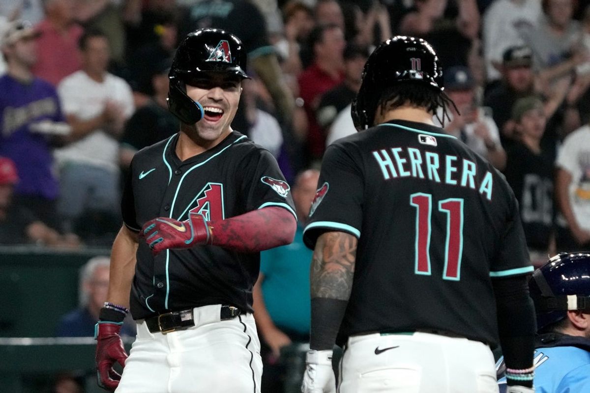 Apr 23, 2025; Phoenix, Arizona, USA; Arizona Diamondbacks outfielder Corbin Carroll (7) celebrates with Acatcher Jose Herrera (11) after hitting a two-run home run against the Tampa Bay Rays during the seventh inning at Chase Field. Mandatory Credit: Rick Scuteri-Imagn Images