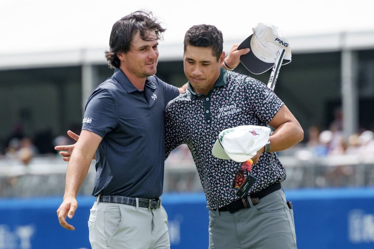Apr 24, 2025; Avondale, Louisiana, USA; Kevin Velo, left, and Isaiah Salinda celebrate making a 58, a new course record, on the 18th hole during the first round of the Zurich Classic of New Orleans golf tournament. Mandatory Credit: Matthew Hinton-Imagn Images