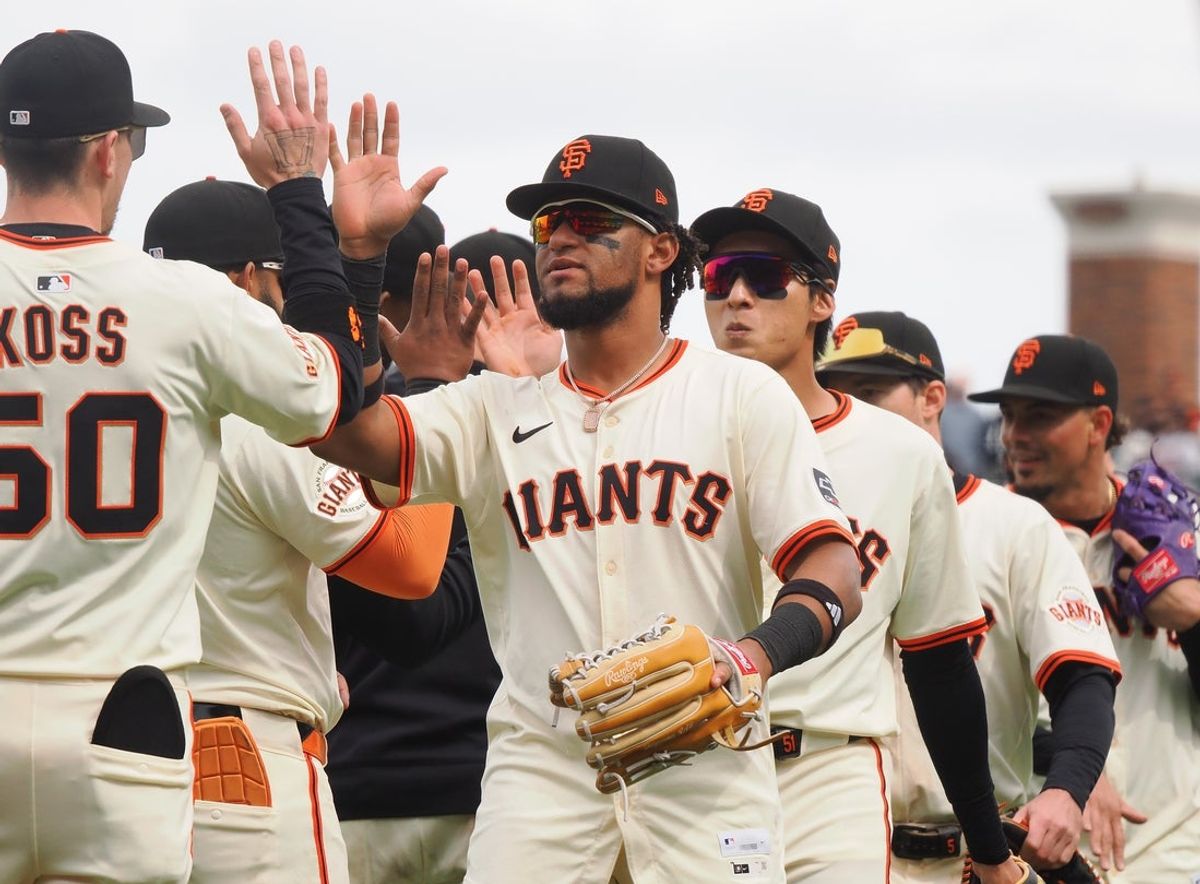 Apr 24, 2025; San Francisco, California, USA; San Francisco Giants players left fielder Luis Matos (29), center fielder Jung Hoo Lee (51) high five teammates after a win against the Milwaukee Brewers at Oracle Park. Mandatory Credit: Kelley L Cox-Imagn Images