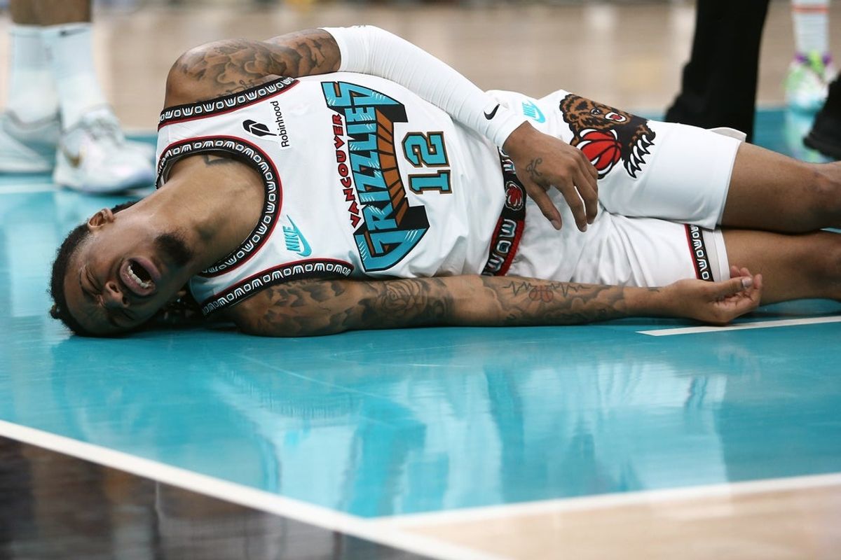 Apr 24, 2025; Memphis, Tennessee, USA; Memphis Grizzlies guard Ja Morant (12) lays on the court after being fouled during the second quarter against the Oklahoma City Thunder during game three for the first round of the 2024 NBA Playoffs at FedExForum. Mandatory Credit: Petre Thomas-Imagn Images