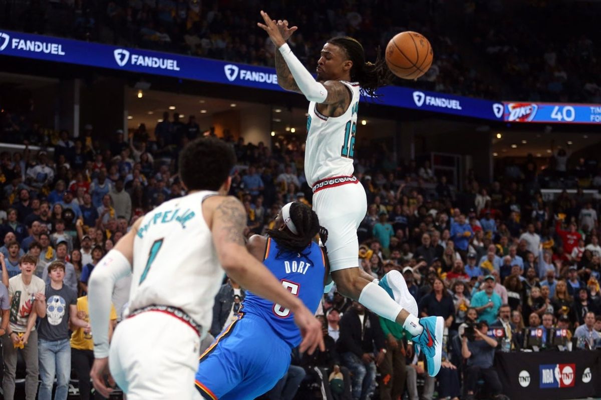 Apr 24, 2025; Memphis, Tennessee, USA; Memphis Grizzlies guard Ja Morant (12) looses control of the ball as he is fouled by Oklahoma City Thunder guard Luguentz Dort (5) during the second quarter during game three for the first round of the 2024 NBA Playoffs at FedExForum. Mandatory Credit: Petre Thomas-Imagn Images