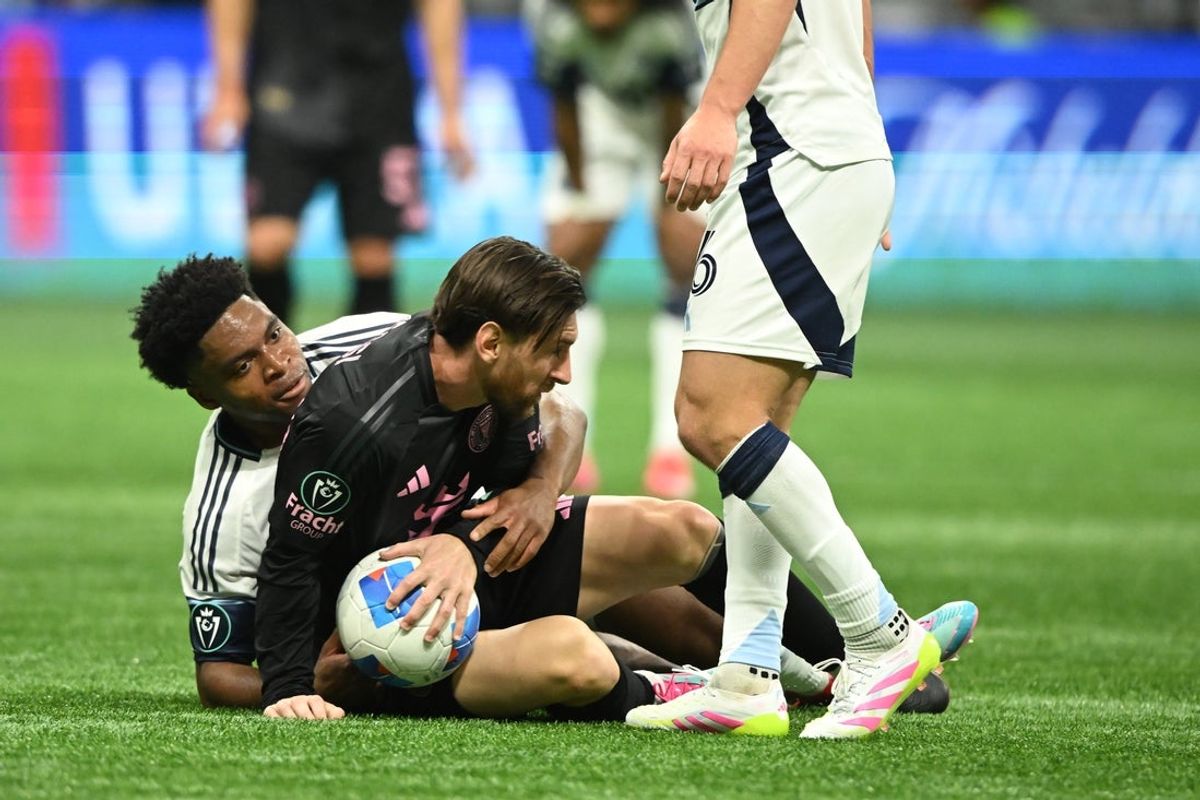Apr 24, 2025; Vancouver, British Columbia, CAN;   Vancouver Whitecaps FC midfielder Ralph Priso (13) fights for the ball against Inter Miami SC forward Lionel Messi (10)during the second half at BC Place. Mandatory Credit: Anne-Marie Sorvin-Imagn Images