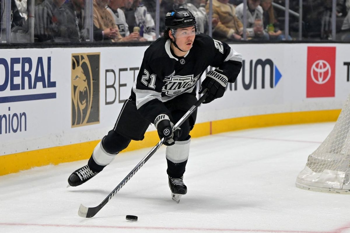 Apr 23, 2025; Los Angeles, California, USA; Los Angeles Kings defenseman Jordan Spence (21) handles the puck during game 2 of the 2025 Stanley Cup Playoffs against the Edmonton Oilers at Crypto.com Arena. Mandatory Credit: Jayne Kamin-Oncea-Imagn Images