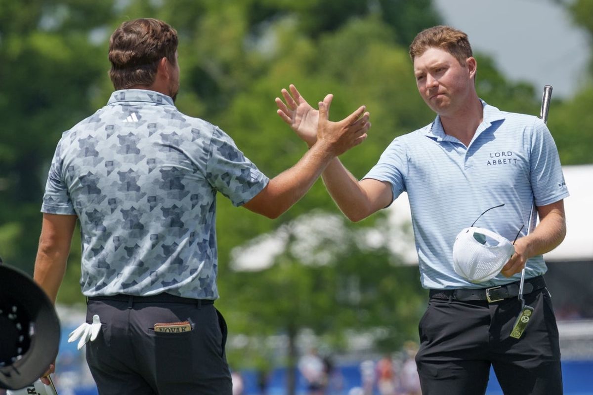 Apr 25, 2025; Avondale, Louisiana, USA; Ben Griffin, right, and Andrew Novak finish up on the 9th hole during the second round of the Zurich Classic of New Orleans golf tournament. Mandatory Credit: Matthew Hinton-Imagn Images