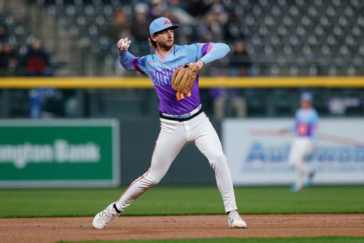 Apr 25, 2025; Denver, Colorado, USA; Colorado Rockies third baseman Ryan McMahon (24) fields and throws to first for an out in the first inning against the Cincinnati Reds at Coors Field. Mandatory Credit: Isaiah J. Downing-Imagn Images