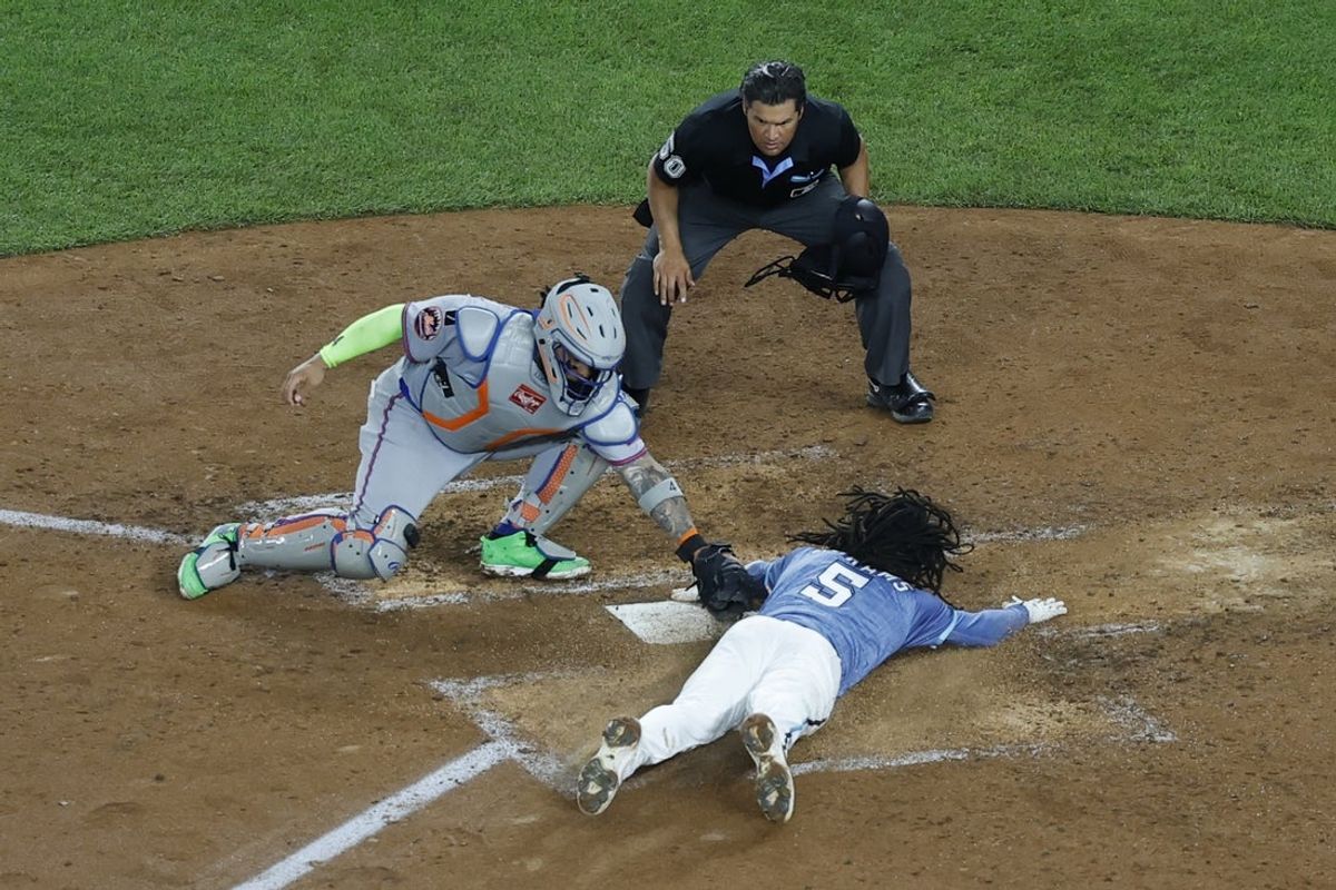 Apr 25, 2025; Washington, District of Columbia, USA; Washington Nationals shortstop CJ Abrams (5) crosses home plate ahead of a tag by New York Mets catcher Fransisco Alvarez (4) to score the game winning run on an RBI single by Nationals outfielder James Wood (not pictured) during the ninth inning at Nationals Park. Mandatory Credit: Geoff Burke-Imagn Images