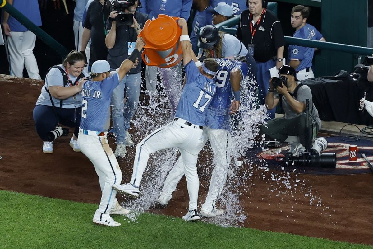 Apr 25, 2025; Washington, District of Columbia, USA; Washington Nationals outfielder James Wood (29) is dumped with a cooler by teammates Nationals second base Luis García Jr. (2) and Nationals outfielder Alex Call (17) during an on field interview after hitting the game-winning RBI single against the New York Mets during the ninth inning at Nationals Park. Mandatory Credit: Geoff Burke-Imagn Images