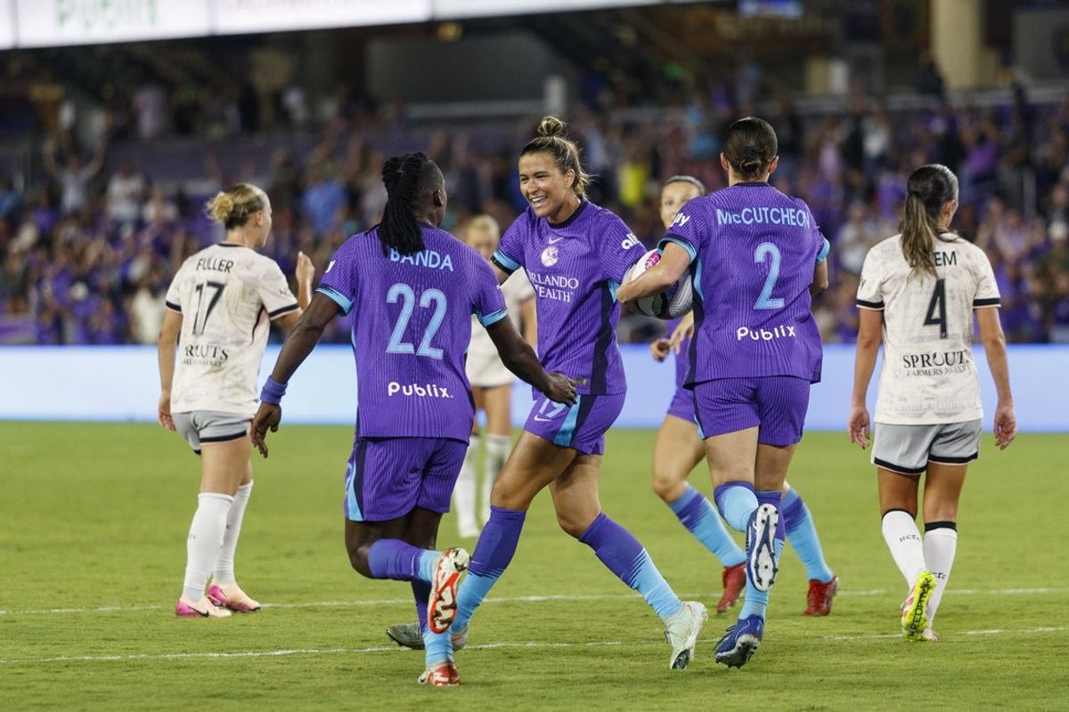 Apr 25, 2025; Orlando, Florida, USA;  Orlando Pride forward Barbra Banda (22) celebrates a goal with defender Carson Pickett (19) and defender Haley McCutcheon (2) against Angel City FC during the second half at Inter&Co Stadium. Mandatory Credit: Morgan Tencza-Imagn Images