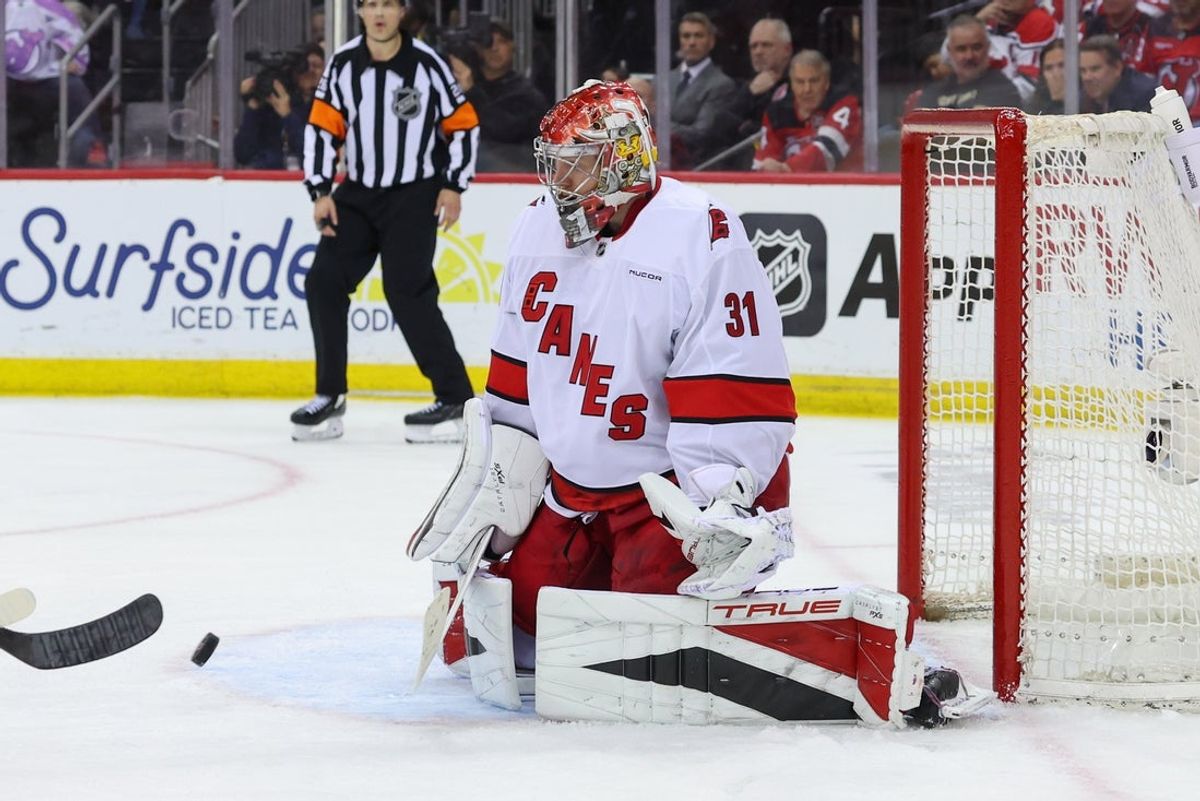 Apr 25, 2025; Newark, New Jersey, USA; Carolina Hurricanes goaltender Frederik Andersen (31) makes a save against the New Jersey Devils during the first overtime in game three of the first round of the 2025 Stanley Cup Playoffs at Prudential Center. Mandatory Credit: Ed Mulholland-Imagn Images