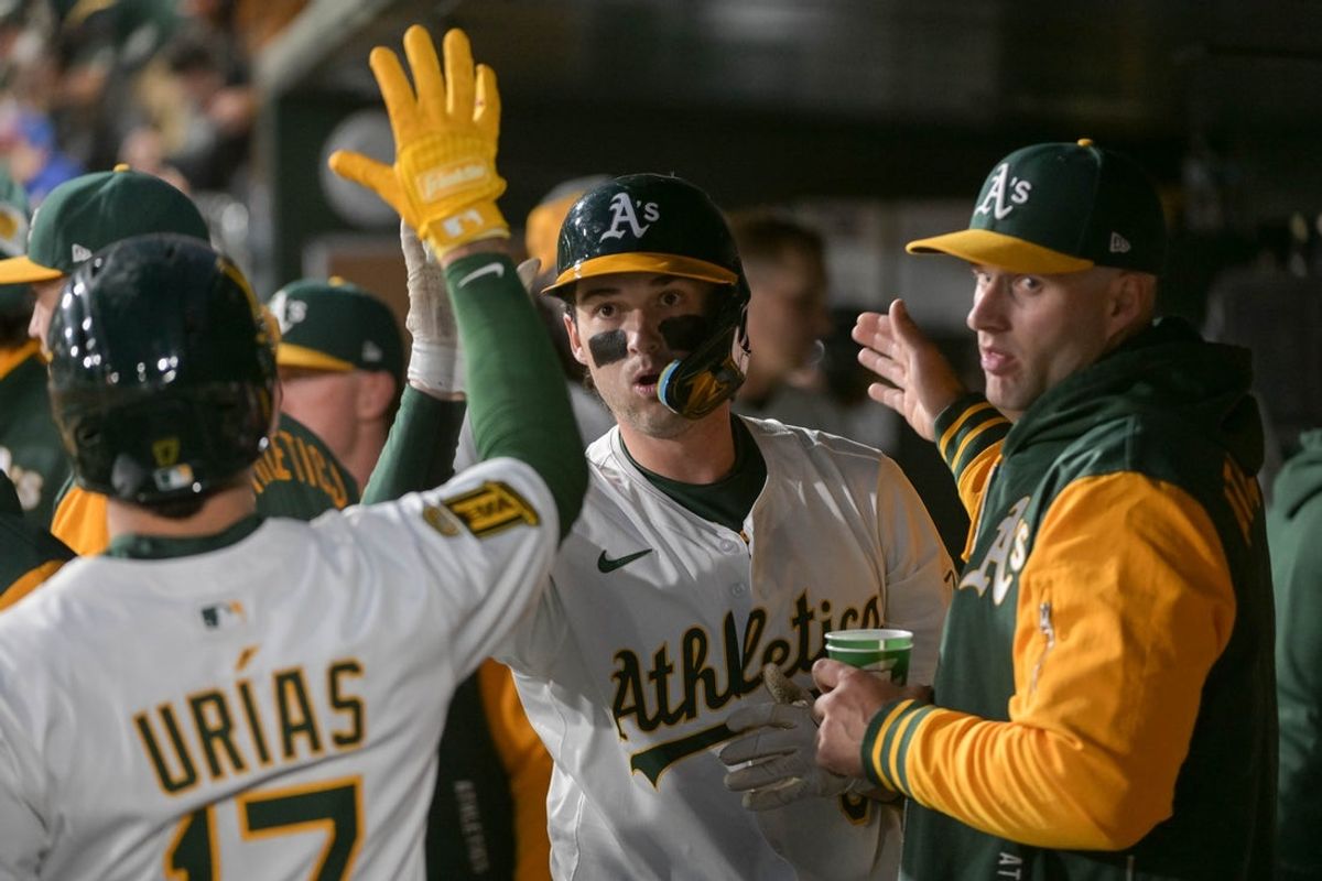 Apr 25, 2025; West Sacramento, California, USA; Athletics shortstop Jacob Wilson (5) celebrates with teammates after hitting a home run against the Chicago White Sox during the fifth inning at Sutter Health Park. Mandatory Credit: Ed Szczepanski-Imagn Images