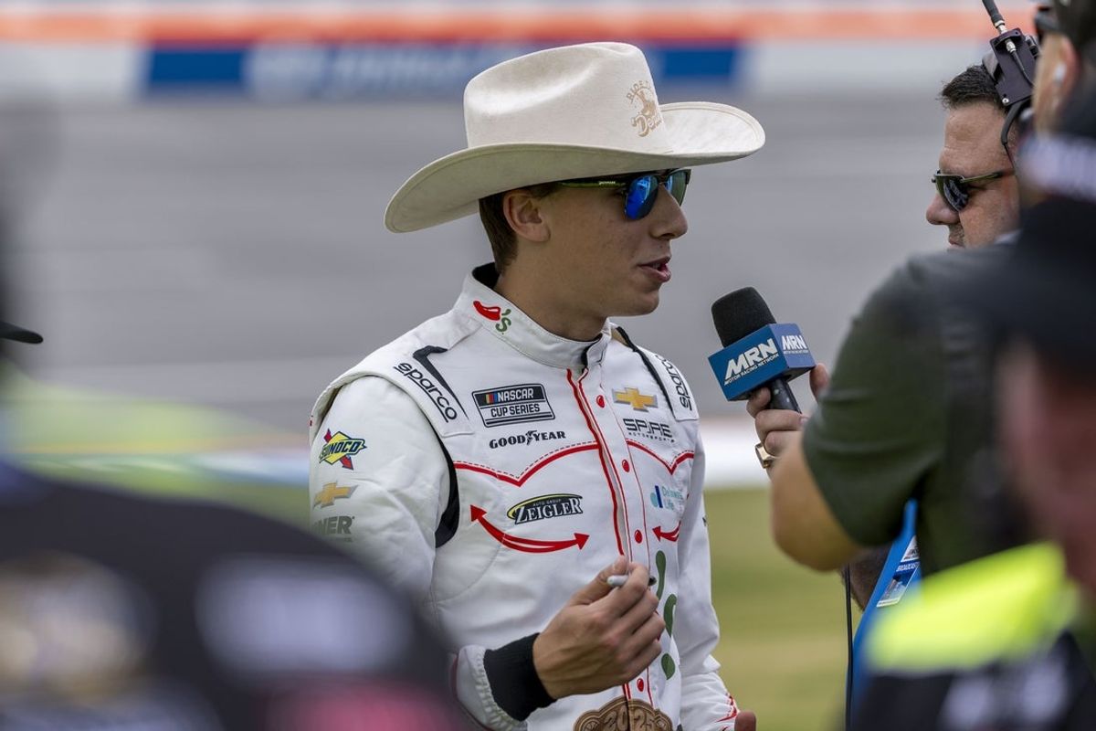 Apr 26, 2025; Talladega, Alabama, USA; NASCAR Cup Series driver Carson Hocevar (77) talks with the media during Jack Link's 500 qualifying at Talladega Superspeedway. Mandatory Credit: Vasha Hunt-Imagn Images