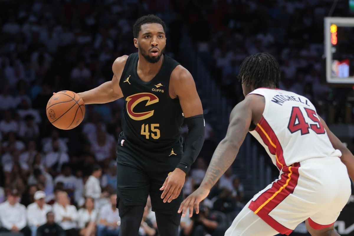 Apr 26, 2025; Miami, Florida, USA; Cleveland Cavaliers guard Donovan Mitchell (45) dribbles the basketball as Miami Heat guard Davion Mitchell (45) defends in the first quarter during game three for the first round of the 2024 NBA Playoffs at Kaseya Center. Mandatory Credit: Sam Navarro-Imagn Images