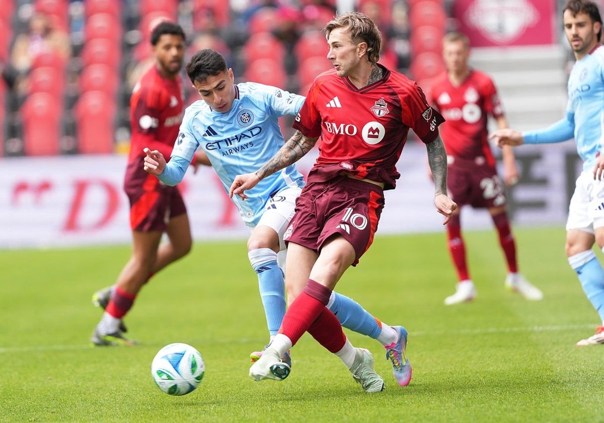 Apr 26, 2025; Toronto, Ontario, CAN; Toronto FC forward Federico Bernardeschi (10) battles for the ball with New York City forward Agustín Ojeda (26) during the first half at BMO Field. Mandatory Credit: Nick Turchiaro-Imagn Images