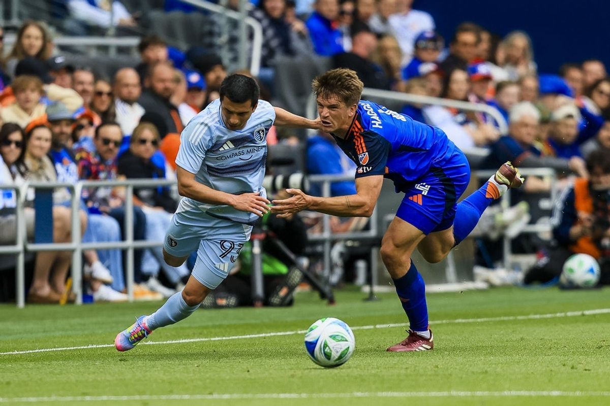 Apr 26, 2025; Cincinnati, Ohio, USA; Sporting Kansas City forward Shapi Suleymanov (93) battles for the ball against FC Cincinnati defender Nick Hagglund (4) in the first half at TQL Stadium. Mandatory Credit: Katie Stratman-Imagn Images