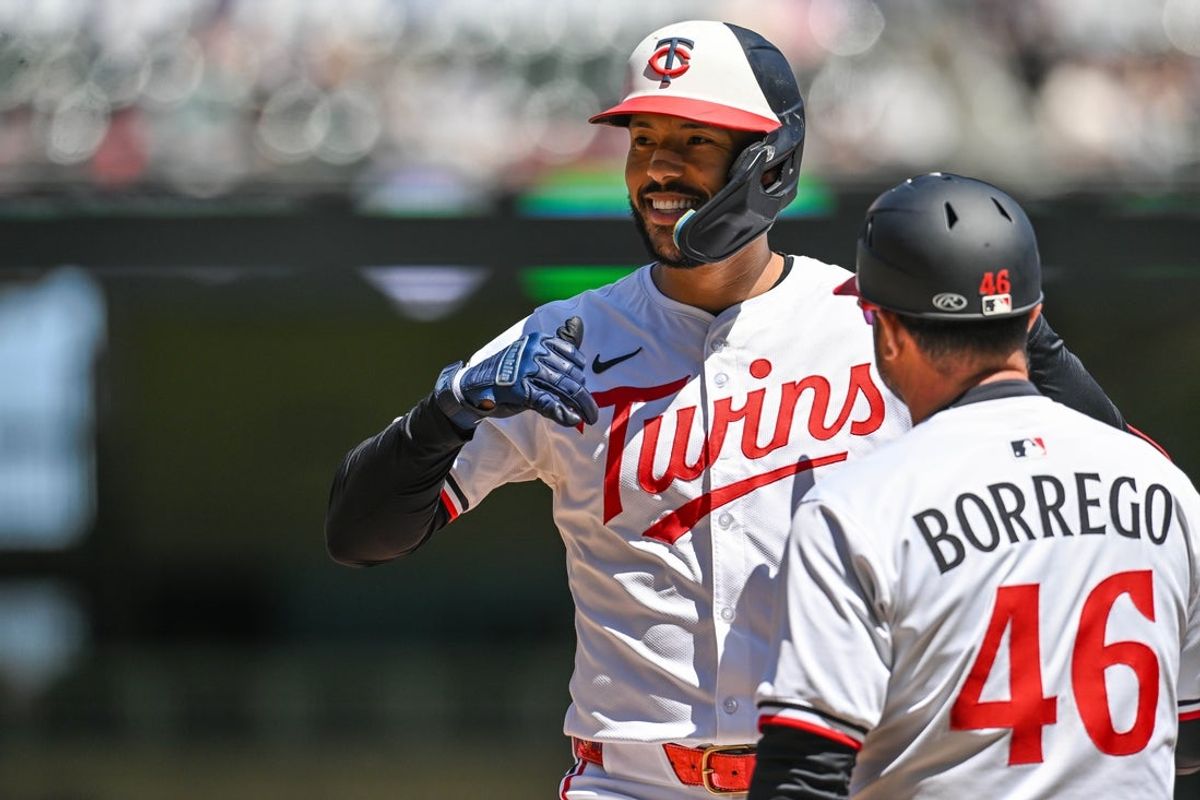 Apr 26, 2025; Minneapolis, Minnesota, USA; Minnesota Twins shortstop Carlos Correa (4) reacts with first base infield coach Ramon Borrego (46) after an RBI single to score catcher Ryan Jeffers (not pictured) off Los Angeles Angels pitcher Yusei Kikuchi (not pictured) during the first inning at Target Field. Mandatory Credit: Jeffrey Becker-Imagn Images