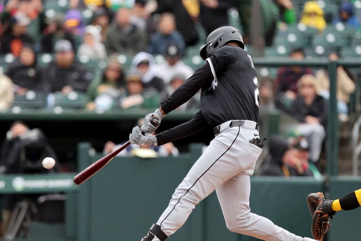 Apr 26, 2025; West Sacramento, California, USA; Chicago White Sox right fielder Michael Taylor (21) hits a double in the first inning against the Athletics at Sutter Health Park. Mandatory Credit: Dennis Lee-Imagn Images