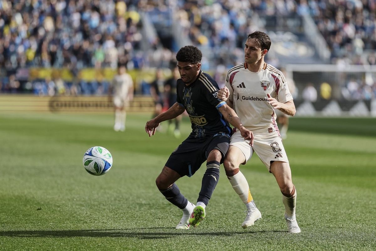 Apr 26, 2025; Chester, Pennsylvania, USA; Philadelphia Union defender Nathan Harriel (26) shields the ball from D.C. United midfielder Jared Stroud (8) during the first half at Subaru Park. Mandatory Credit: Caean Couto-Imagn Images