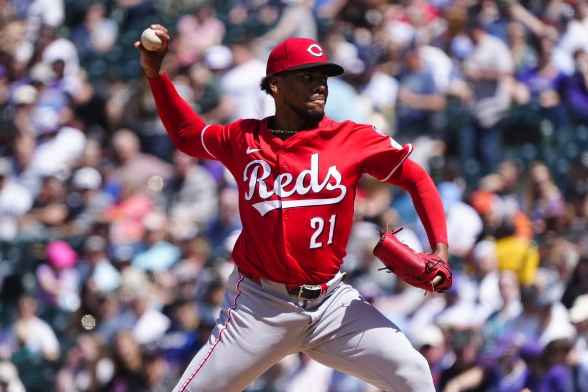 Apr 26, 2025; Denver, Colorado, USA; Cincinnati Reds starting pitcher Hunter Greene (21) delivers a pitch n the fourth inning against the Colorado Rockies at Coors Field. Mandatory Credit: Ron Chenoy-Imagn Images