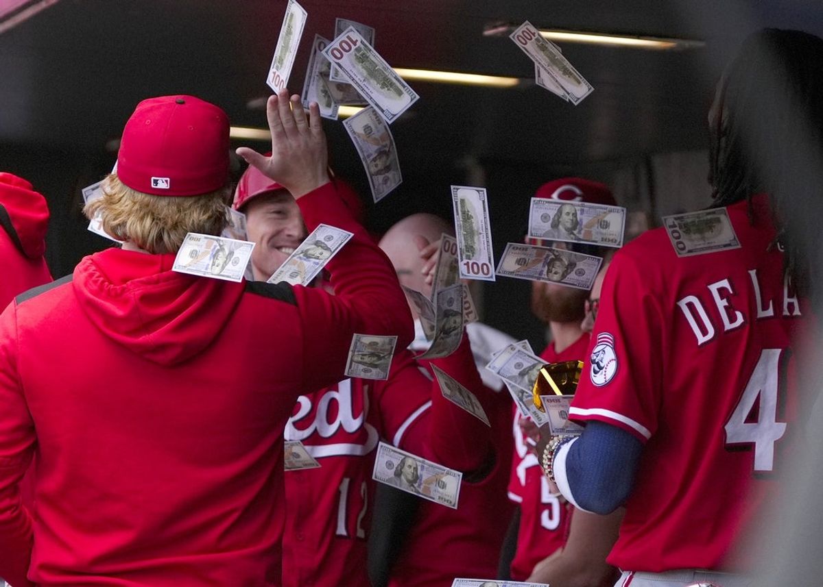 Apr 26, 2025; Denver, Colorado, USA; Cincinnati Reds outfielder Austin Hays (12) celebrates his solo home run in the sixth inning against the Colorado Rockies at Coors Field. Mandatory Credit: Ron Chenoy-Imagn Images