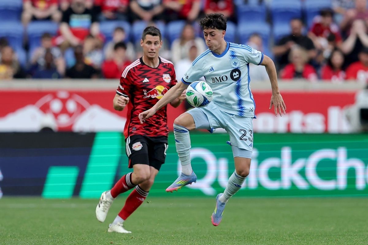 Apr 26, 2025; Harrison, New Jersey, USA; CF Montreal midfielder Caden Clark (23) controls the ball against New York Red Bulls defender Sean Nealis (15) during the second half at Sports Illustrated Stadium. Mandatory Credit: Brad Penner-Imagn Images