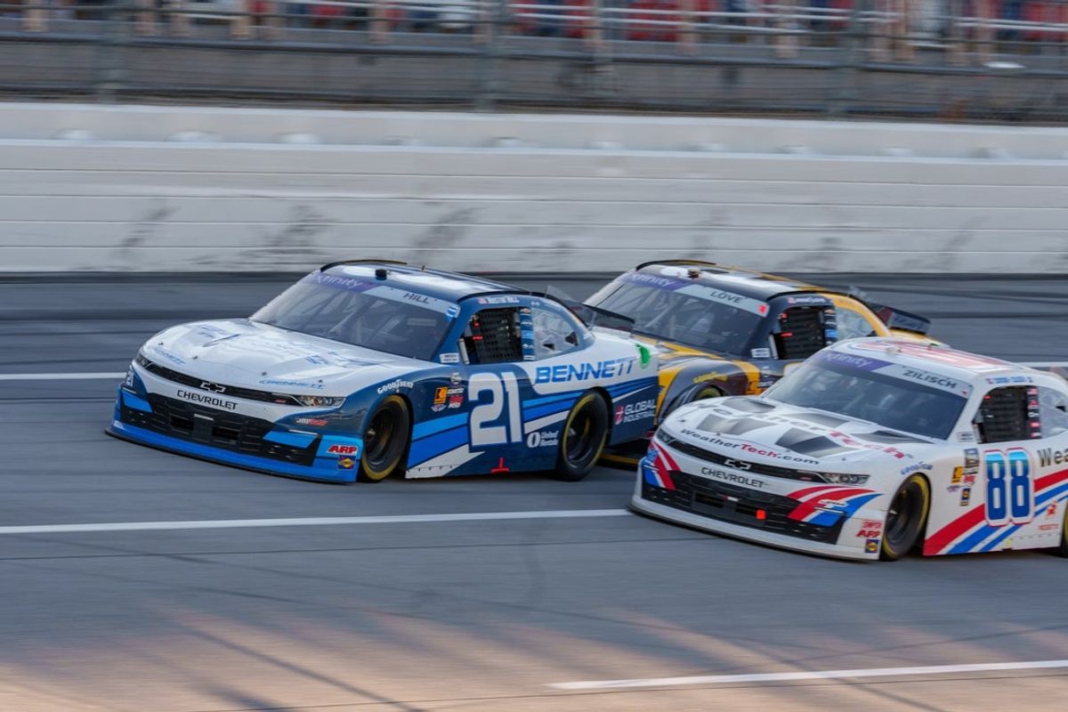 Apr 26, 2025; Talladega, Alabama, USA; Xfinity Series driver Austin Hill (21) leads the pack into turn one at Talladega Superspeedway. Mandatory Credit: Jason Allen-Imagn Images