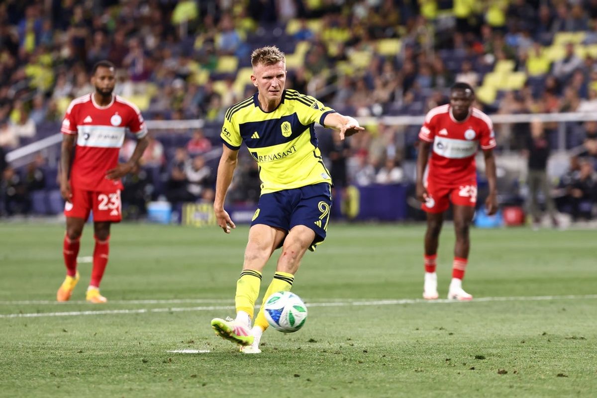 Apr 26, 2025; Nashville, Tennessee, USA; Nashville SC forward Sam Surridge (9) kicks a penalty kick in the first half of the match against the Chicago Fire at Geodis Park. Mandatory Credit: Casey Gower-Imagn Images