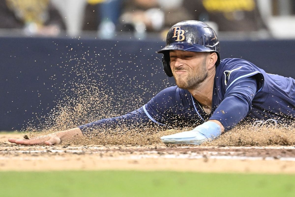Apr 26, 2025; San Diego, California, USA; Tampa Bay Rays second baseman Brandon Lowe (8) slides as he scores during the fifth inning against the San Diego Padres at Petco Park. Mandatory Credit: Denis Poroy-Imagn Images