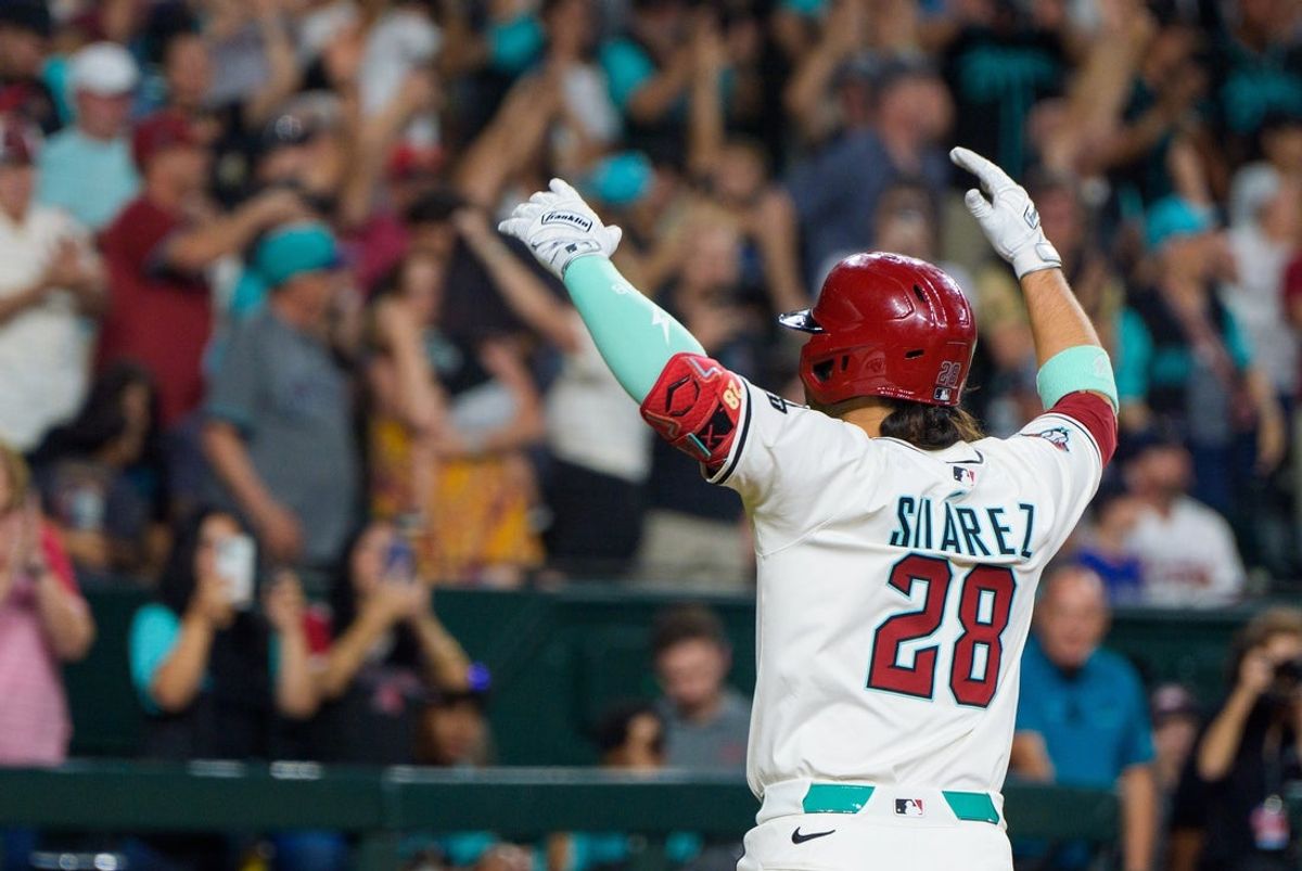 Apr 26, 2025; Phoenix, Arizona, USA;  Arizona Diamondbacks infielder Eugenio Suarez (28) reacts after hitting his fourth home run of the game against the Atlanta Braves during the ninth inning at Chase Field. Mandatory Credit: Allan Henry-Imagn Images