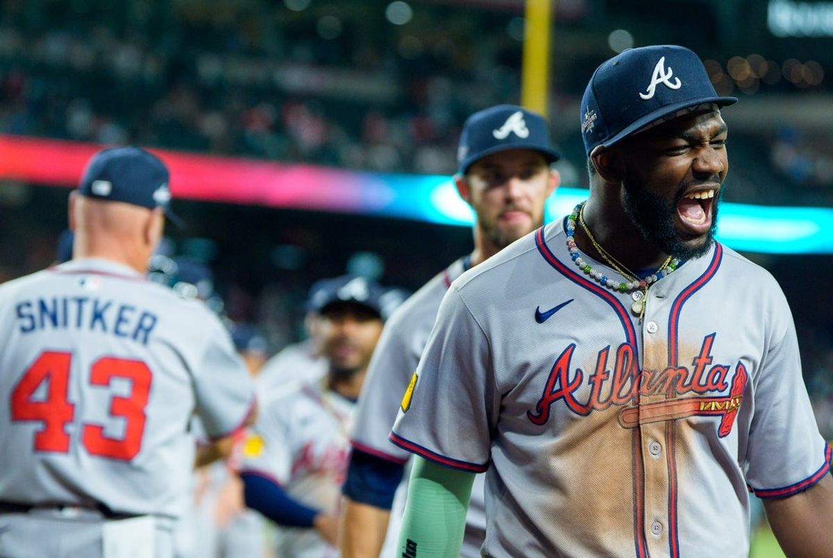 Apr 26, 2025; Phoenix, Arizona, USA;  Atlanta Braves infielder Ozzie Albies (1) celebrates with his team after beating the Arizona Diamondbacks in extra inning at Chase Field. The Braves beat the Diamondbacks 8-7. Mandatory Credit: Allan Henry-Imagn Images