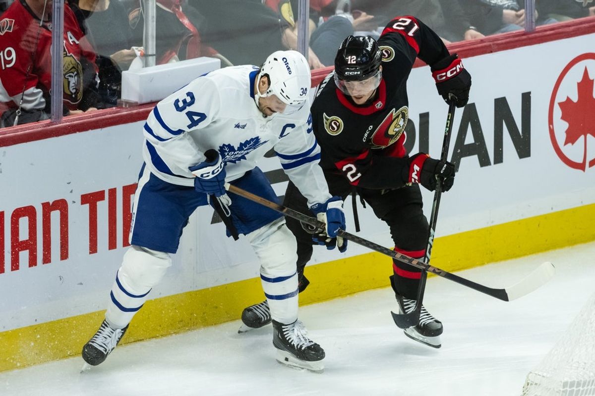 Apr 26, 2025; Ottawa, Ontario, CAN; Toronto Maple Leafs center Auston Matthews (34) battles with Ottawa Senators center Shane Pinto (12) in game four of the first round of the 2025 Stanley Cup Playoffs at Canadian Tire Centre. Mandatory Credit: Marc DesRosiers-Imagn Images