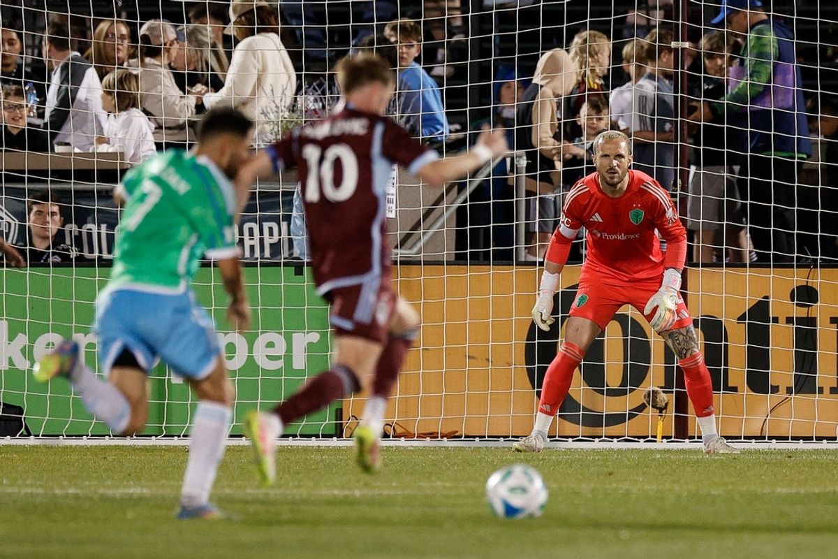Apr 26, 2025; Commerce City, Colorado, USA; Seattle Sounders goalkeeper Stefan Frei (24) watches as Colorado Rapids midfielder Djordje Mihailovic (10) and midfielder Cristian Roldan (7) battle for the ball in the second half at Dick's Sporting Goods Park. Mandatory Credit: Isaiah J. Downing-Imagn Images