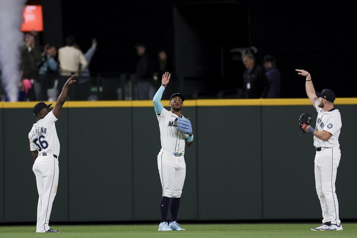 Apr 26, 2025; Seattle, Washington, USA; Seattle Mariners outfielders, from left, Randy Arozarena, Julio Rodriguez, and Luke Raley, celebrate after the team’s win in an MLB game against the Miami Marlins at T-Mobile Park. Mandatory Credit: Ryan Sun-Imagn Images