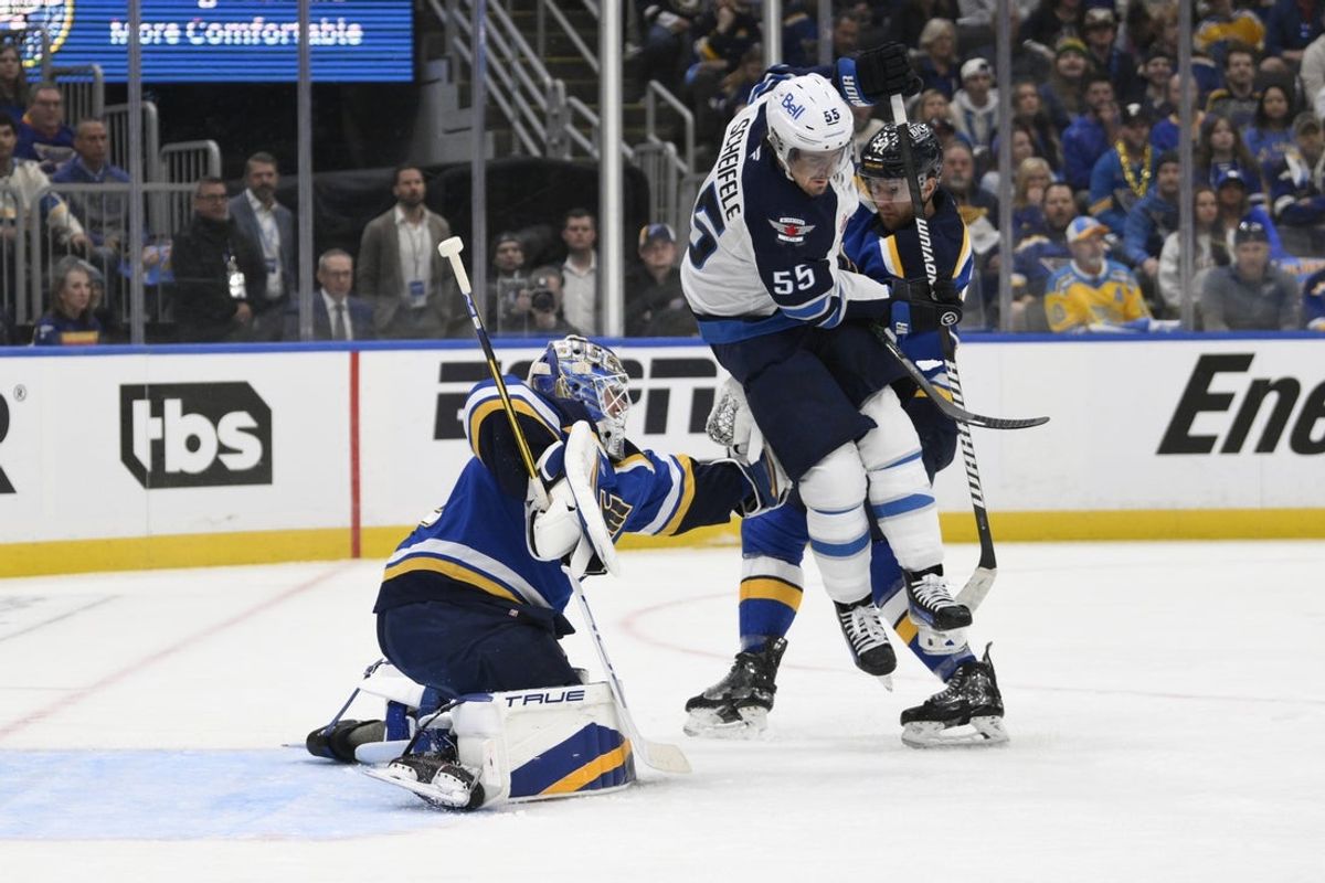 Apr 27, 2025; St. Louis, Missouri, USA; Winnipeg Jets center Mark Scheifele (55) attempts to screen St. Louis Blues goaltender Jordan Binnington (50) during the first period in game four of the first round of the 2025 Stanley Cup Playoffs at Enterprise Center. Mandatory Credit: Jeff Le-Imagn Images