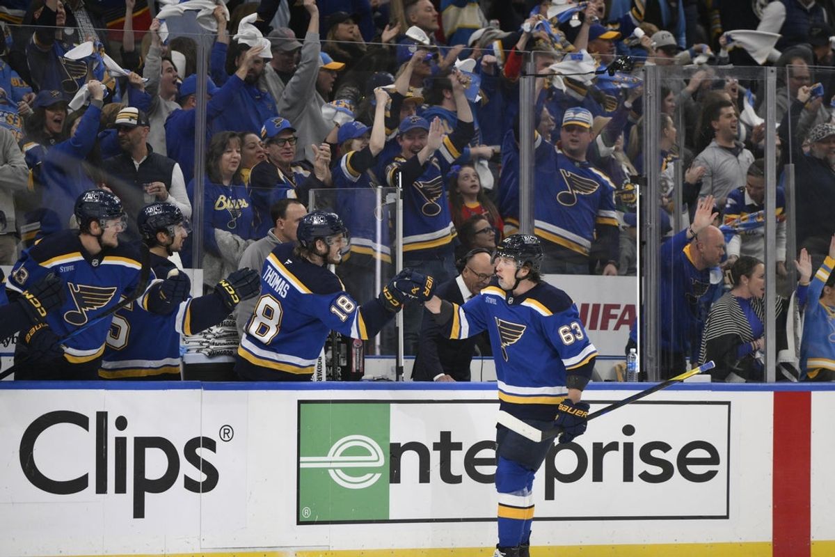 Apr 27, 2025; St. Louis, Missouri, USA; St. Louis Blues left wing Jake Neighbours (63) is congratulated by teammates after scoring a goal against the Winnipeg Jets during the first period in game four of the first round of the 2025 Stanley Cup Playoffs at Enterprise Center. Mandatory Credit: Jeff Le-Imagn Images