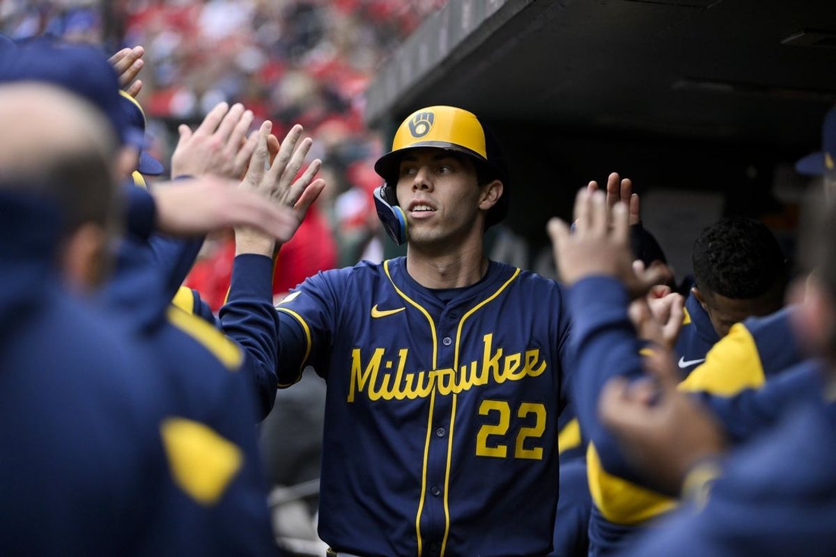 Apr 27, 2025; St. Louis, Missouri, USA;  Milwaukee Brewers designated hitter Christian Yelich (22) is congratulated by teammates after scoring against the St. Louis Cardinals during the first inning at Busch Stadium. Mandatory Credit: Jeff Curry-Imagn Images