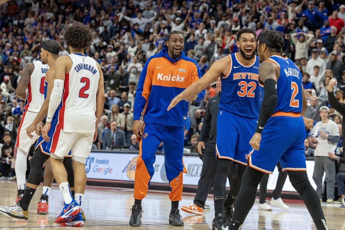 Apr 27, 2025; Detroit, Michigan, USA; Detroit Pistons guard Cade Cunningham (2) walks away as New York Knicks center Karl-Anthony Towns (32) celebrates the win during game four of first round for the 2025 NBA Playoffs at Little Caesars Arena. Mandatory Credit: David Reginek-Imagn Images