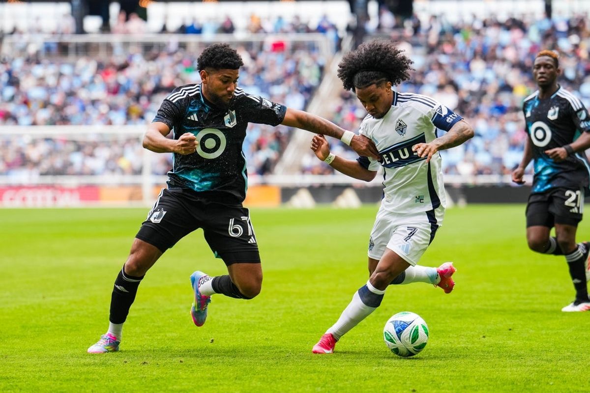 Apr 27, 2025; Saint Paul, Minnesota, USA; Vancouver Whitecaps forward Jayden Nelson (7) attempts to dribble past Minnesota United midfielder Carlos Harvey (67) during the first half at Allianz Field. Mandatory Credit: Brace Hemmelgarn-Imagn Images