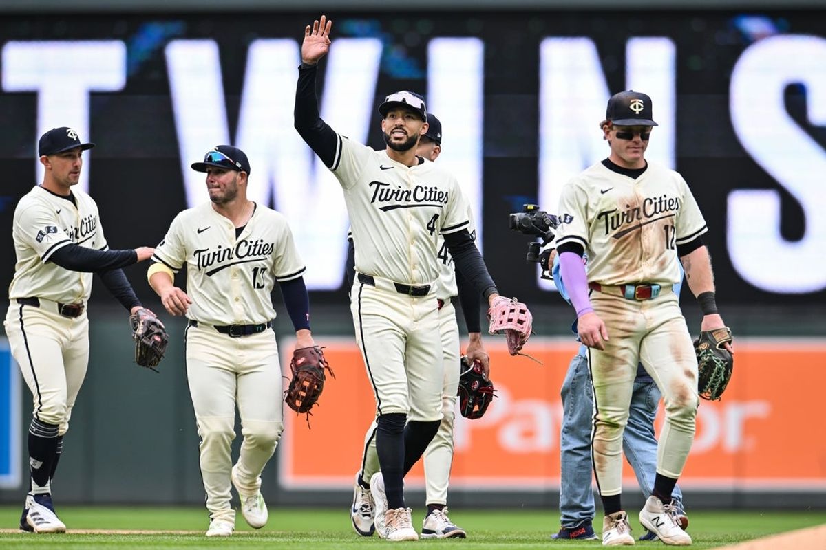 Apr 27, 2025; Minneapolis, Minnesota, USA; Minnesota Twins shortstop Carlos Correa (4) reacts to the crowd with outfielder Harrison Bader (12) and teammates after the game against the Los Angeles Angels at Target Field. Mandatory Credit: Jeffrey Becker-Imagn Images