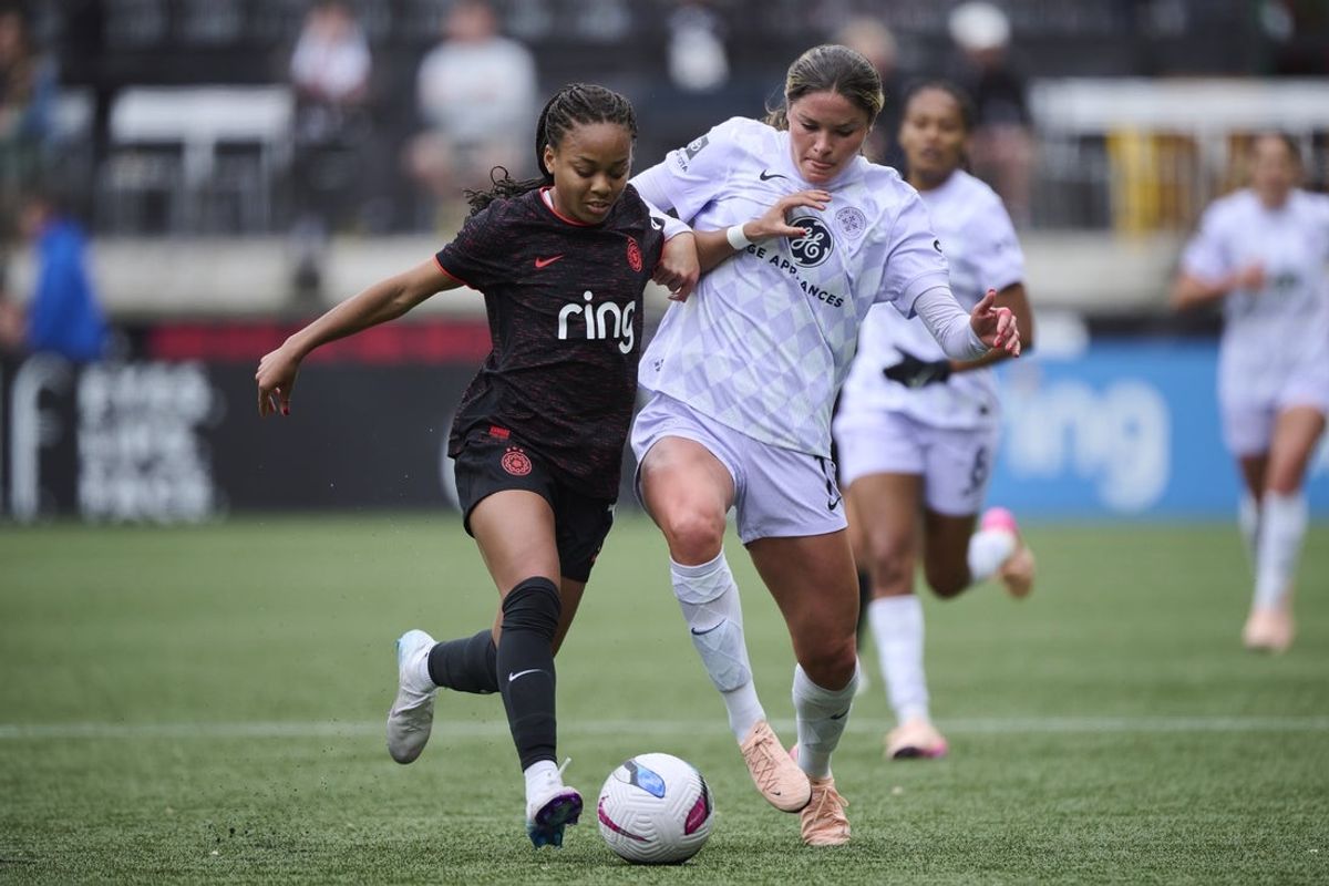 Apr 27, 2025; Portland, Oregon, USA; Portland Thorns FC forward Caiya Hanks (7) struggles to control the ball during the first half against Racing Louisville FC forward Emma Sears (13) at Providence Park. Mandatory Credit: Troy Wayrynen-Imagn Images