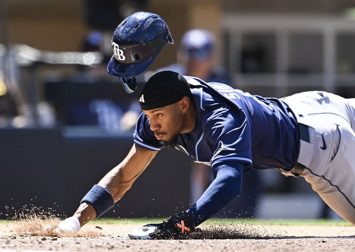 Apr 27, 2025; San Diego, California, USA; Tampa Bay Rays shortstop Chandler Simpson (14) dives to score on a wild pitch during the fifth inning against the San Diego Padres at Petco Park. Mandatory Credit: Denis Poroy-Imagn Images