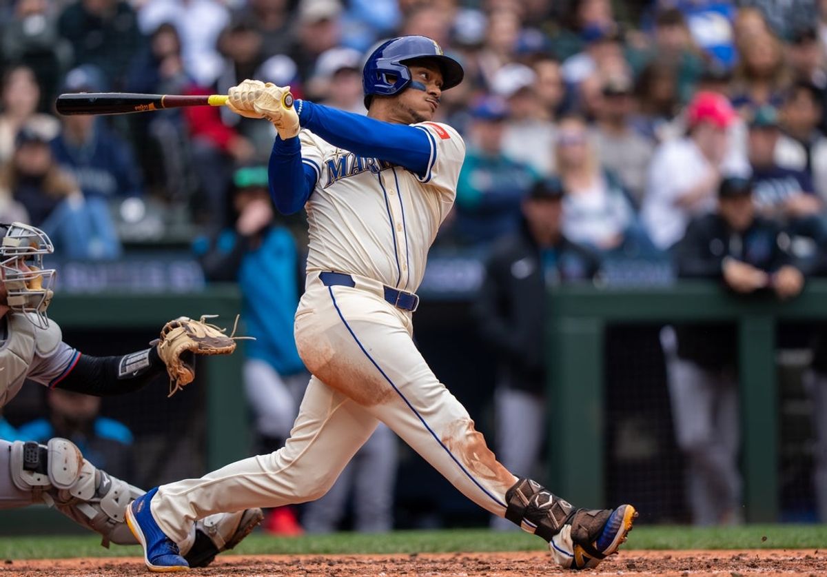Apr 27, 2025; Seattle, Washington, USA;  Seattle Mariners designated hitter Jorge Polanco (7) hits a RBI-single during the fourth inning against the Miami Marlins at Lumen Field. Mandatory Credit: Stephen Brashear-Imagn Images