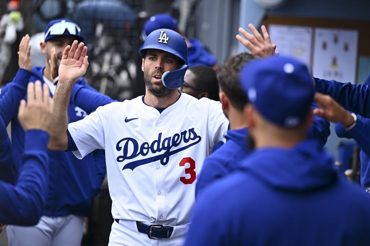 Apr 27, 2025; Los Angeles, California, USA; Los Angeles Dodgers outfielder Chris Taylor (3) celebrates with teammates in the dugout after scoring against the Pittsburgh Pirates during the sixth inning at Dodger Stadium. Mandatory Credit: Jonathan Hui-Imagn Images