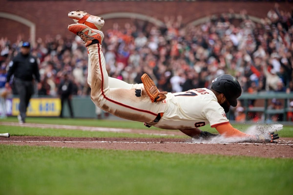 Apr 27, 2025; San Francisco, California, USA; San Francisco Giants outfielder Heliot Ramos (17) scores the walk-off run against the Texas Rangers during the ninth inning at Oracle Park. Mandatory Credit: Robert Edwards-Imagn Images