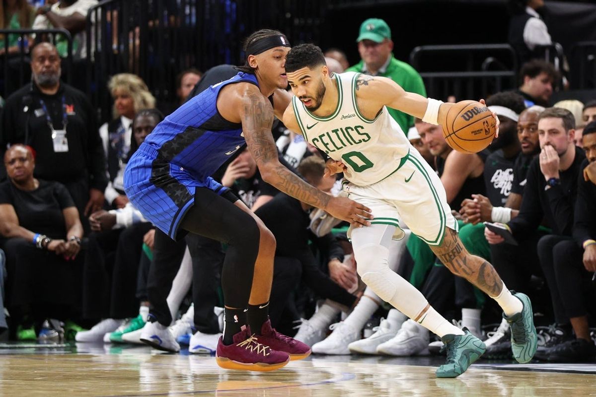 Apr 27, 2025; Orlando, Florida, USA; Boston Celtics forward Jayson Tatum (0) is guarded by Orlando Magic forward Paolo Banchero (5) in the second quarter during game four of first round for the 2025 NBA Playoffs at Kia Center. Mandatory Credit: Nathan Ray Seebeck-Imagn Images