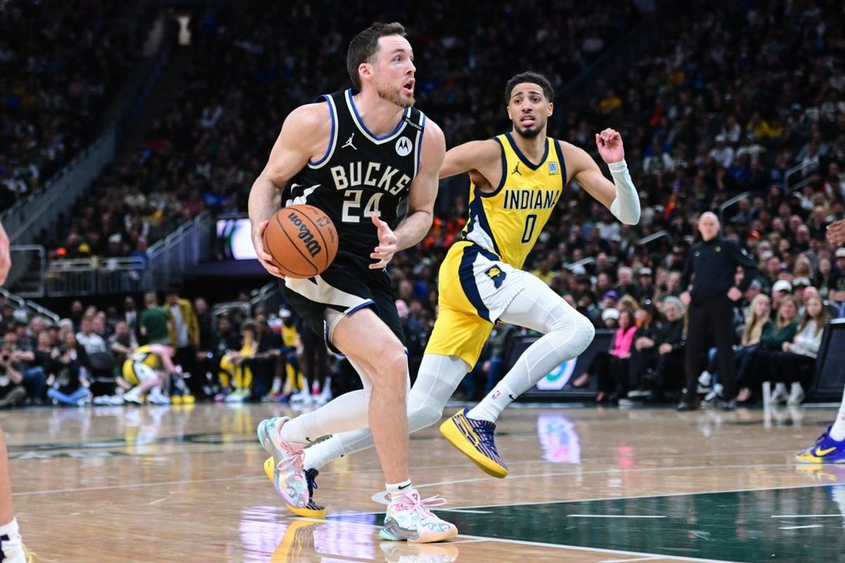 Apr 27, 2025; Milwaukee, Wisconsin, USA; Milwaukee Bucks guard Pat Connaughton (24) drives for the basket against Indiana Pacers guard Tyrese Haliburton (0) in the fourth quarter during game four of first round for the 2024 NBA Playoffs at Fiserv Forum. Mandatory Credit: Benny Sieu-Imagn Images
