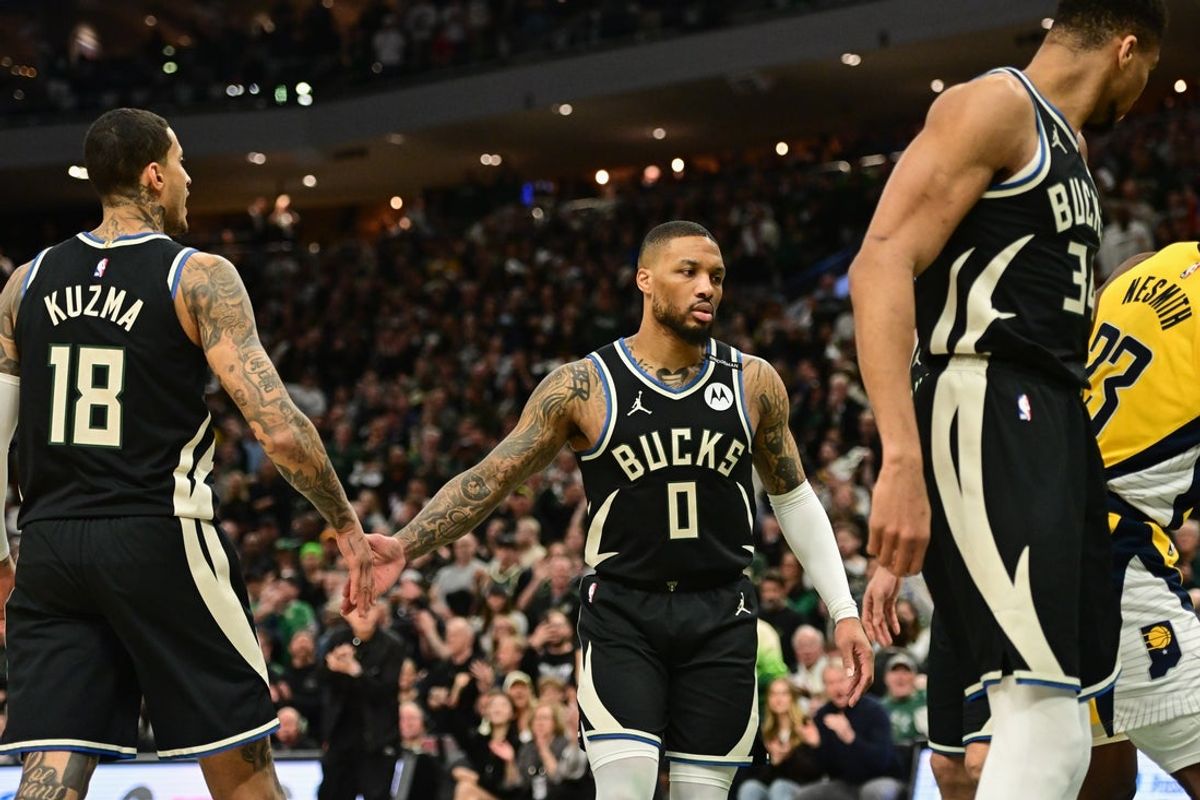 Apr 27, 2025; Milwaukee, Wisconsin, USA; Milwaukee Bucks guard Damian Lillard (0) reacts with forward Kyle Kuzma (18) in the first quarter against the Indiana Pacers during game four of first round for the 2024 NBA Playoffs at Fiserv Forum. Lillard left the game early in the in the first quarter with an injury. Mandatory Credit: Benny Sieu-Imagn Images