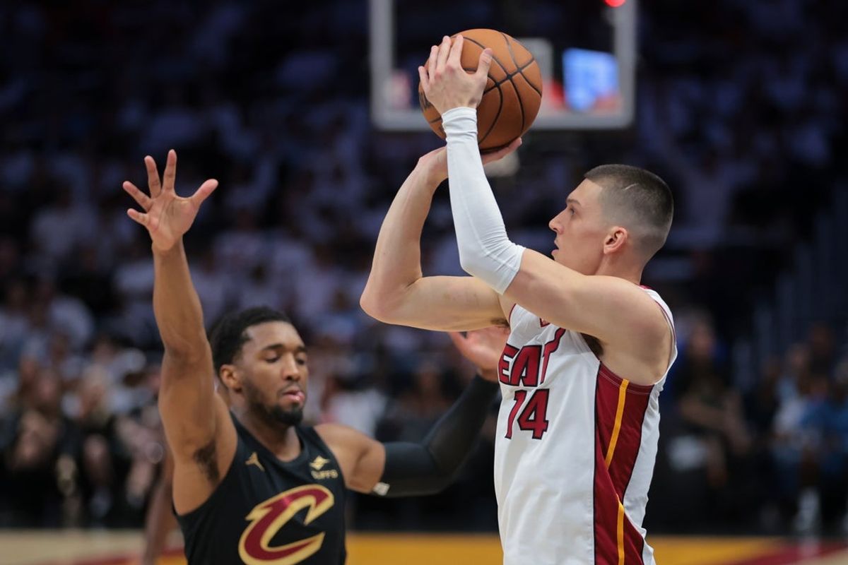 Apr 28, 2025; Miami, Florida, USA; Miami Heat guard Tyler Herro (14) shoots the basketball over Cleveland Cavaliers guard Donovan Mitchell (45) in the first quarter during game four for the first round of the 2025 NBA Playoffs at Kaseya Center. Mandatory Credit: Sam Navarro-Imagn Images
