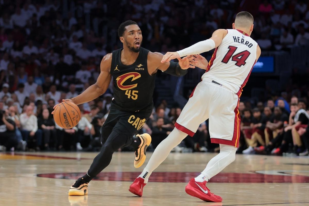 Apr 28, 2025; Miami, Florida, USA; Cleveland Cavaliers guard Donovan Mitchell (45) dribbles the basketball as Miami Heat guard Tyler Herro (14) defends in the second quarter during game four for the first round of the 2025 NBA Playoffs at Kaseya Center. Mandatory Credit: Sam Navarro-Imagn Images